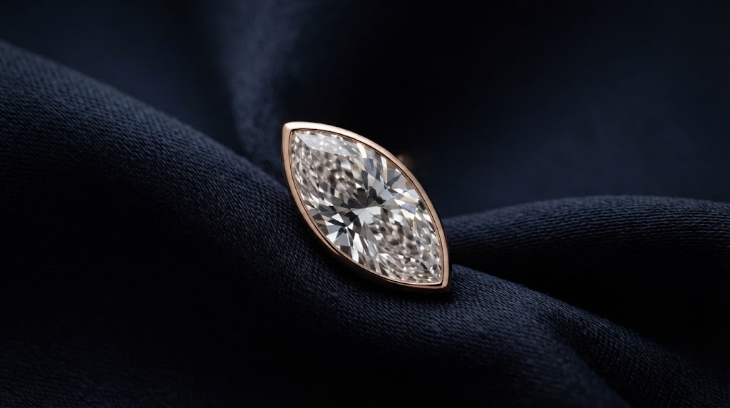 A marquise-cut diamond on dark navy silk