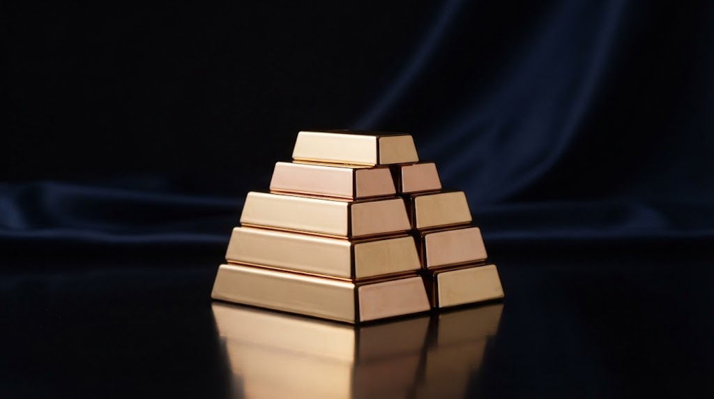A stack of polished gold bars on a dark reflective surface